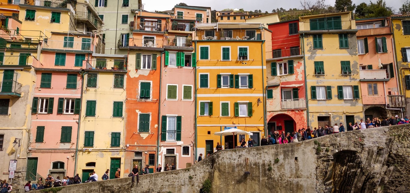 A picture of a row of colourful houses in Riomaggiore, Italy in Cinque Terre