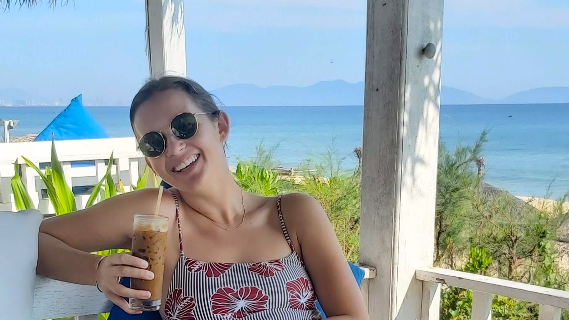 A woman drinking a typical Vietnamese coffee at a beach front bar in An Bang.