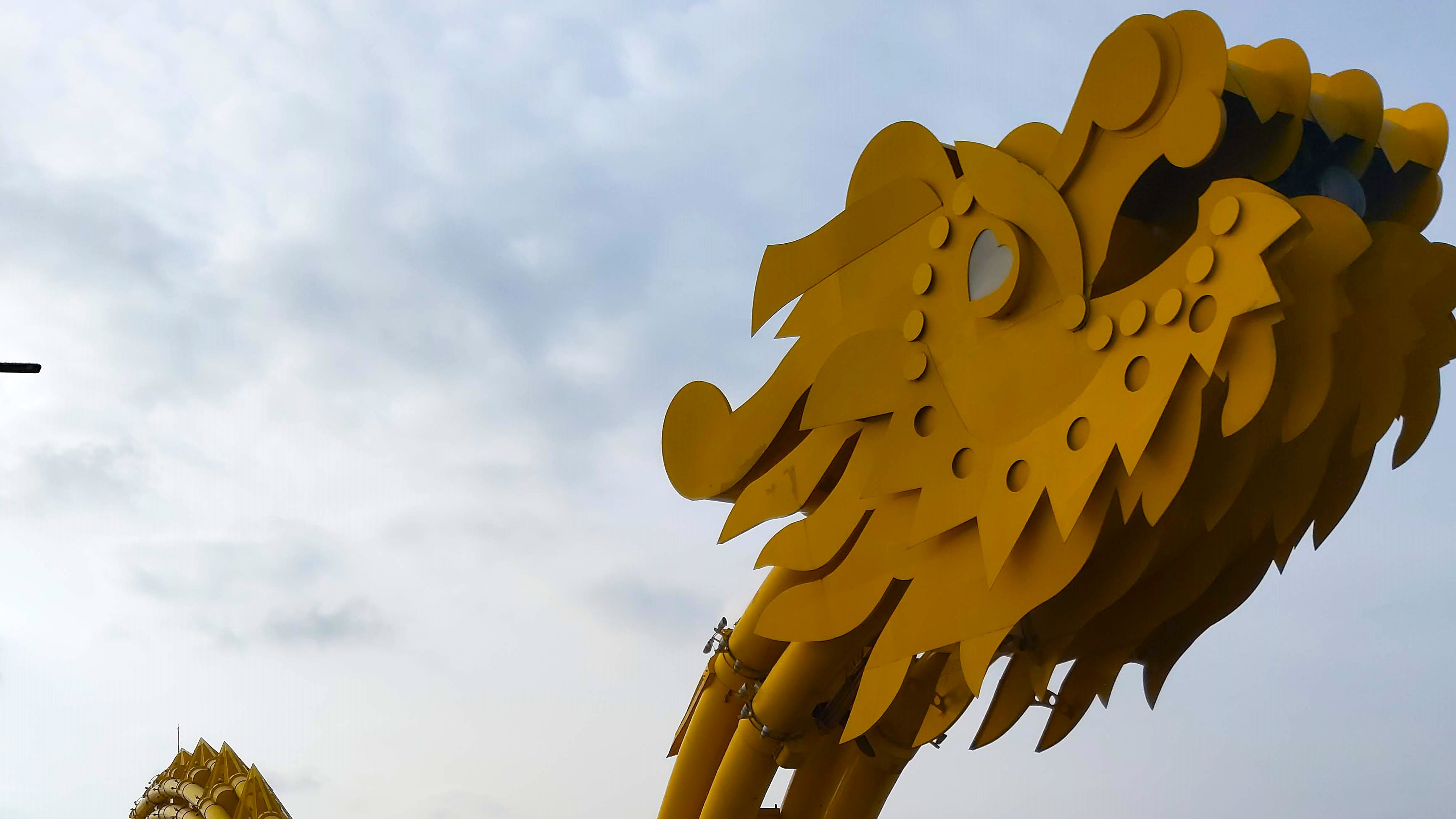 A close-up of the golden Dragon Bridge's face in Da Nang