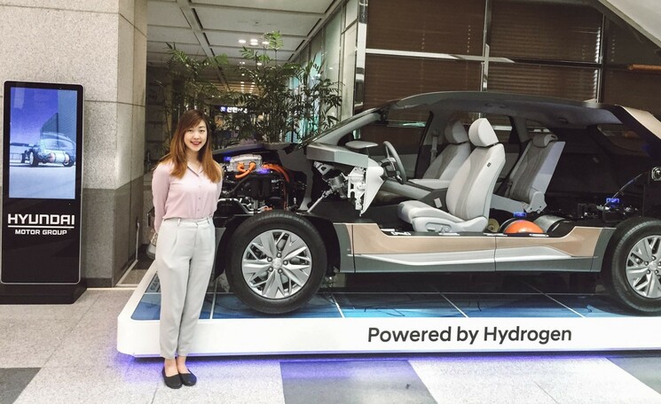 Foreign employee for Kia posing in the showroom in Seoul, South Korea