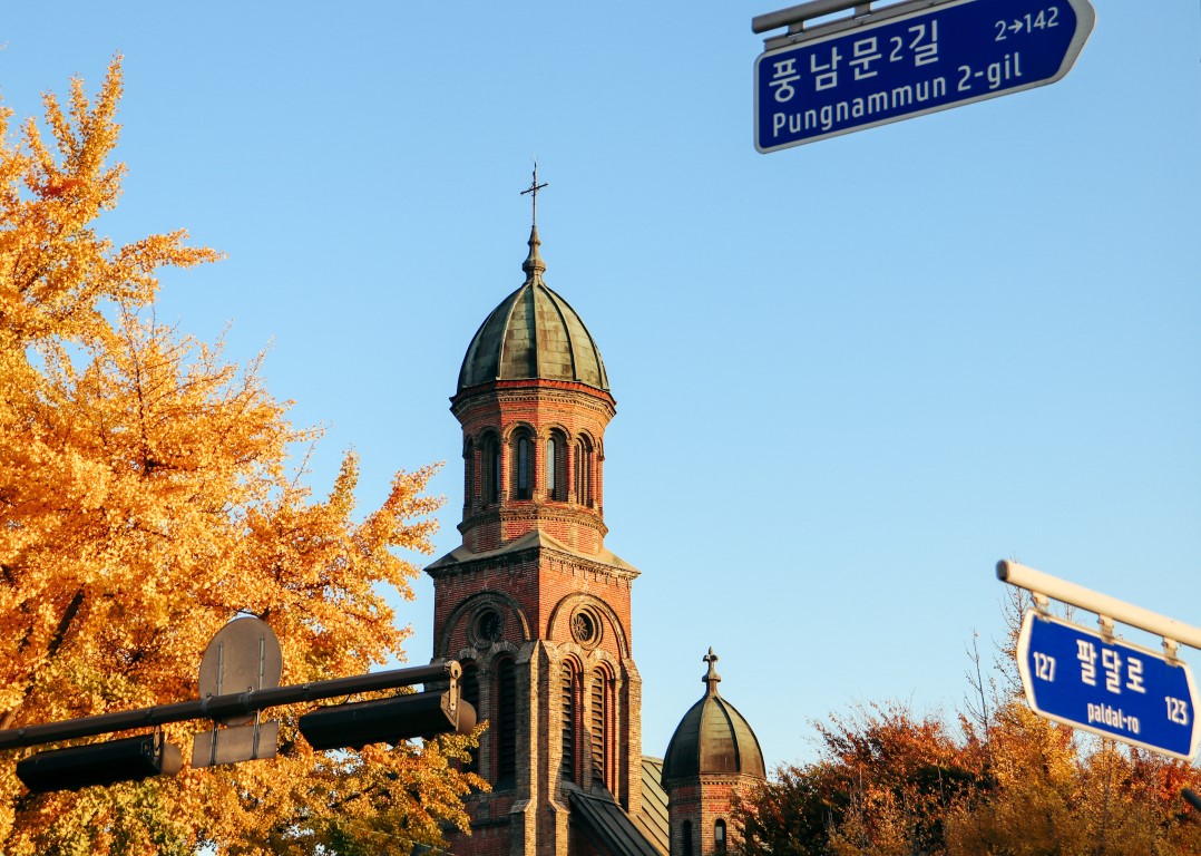 a western style church with fall leaves in jeonju, korea