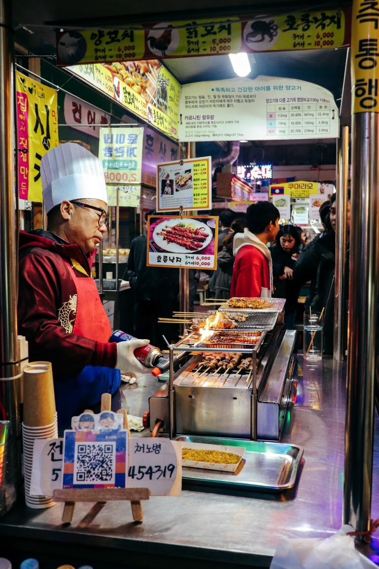man cooking street food in jeonju, korea