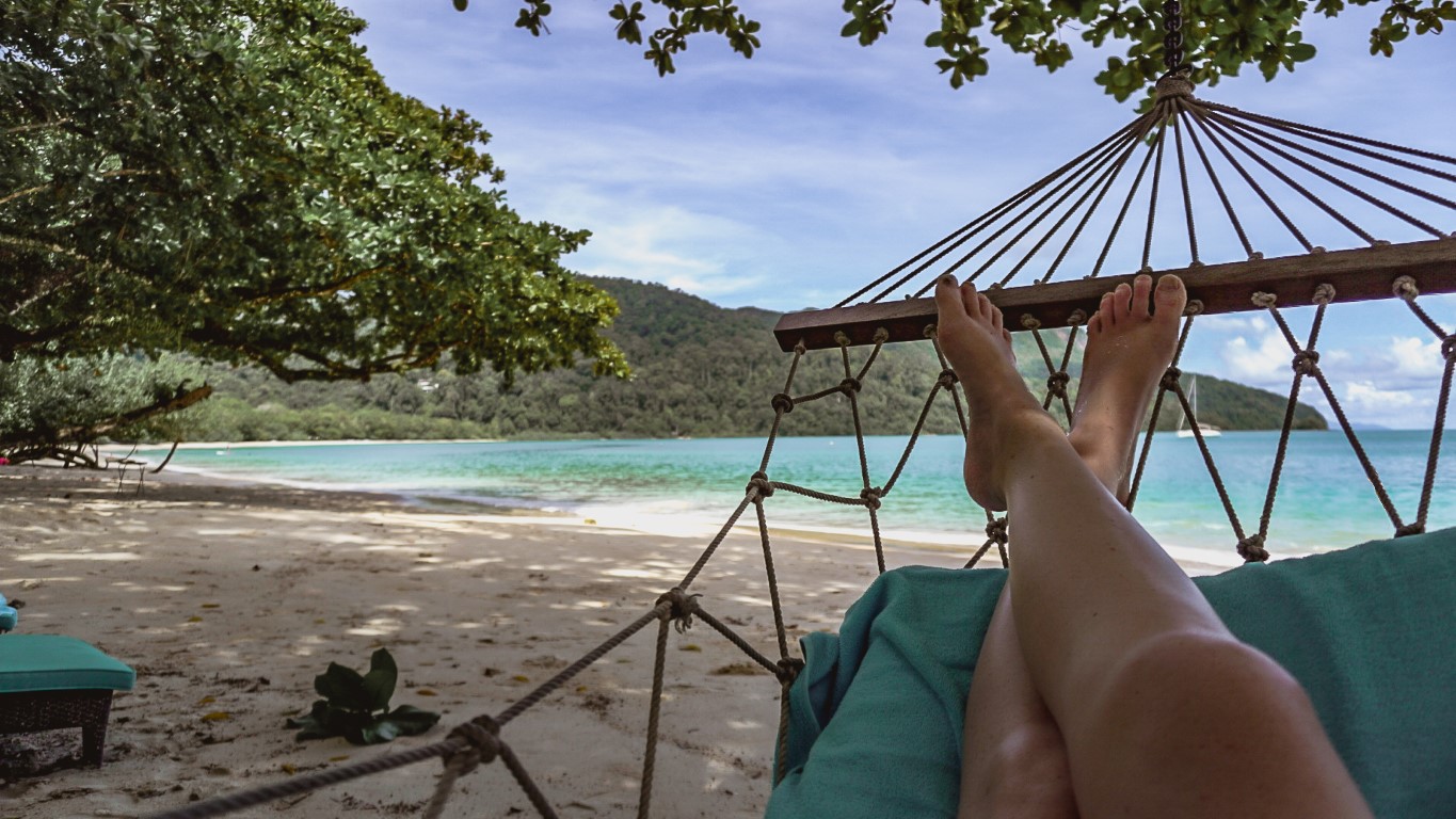 a woman resting in a hammock on the beach in Langkawi, Malaysia