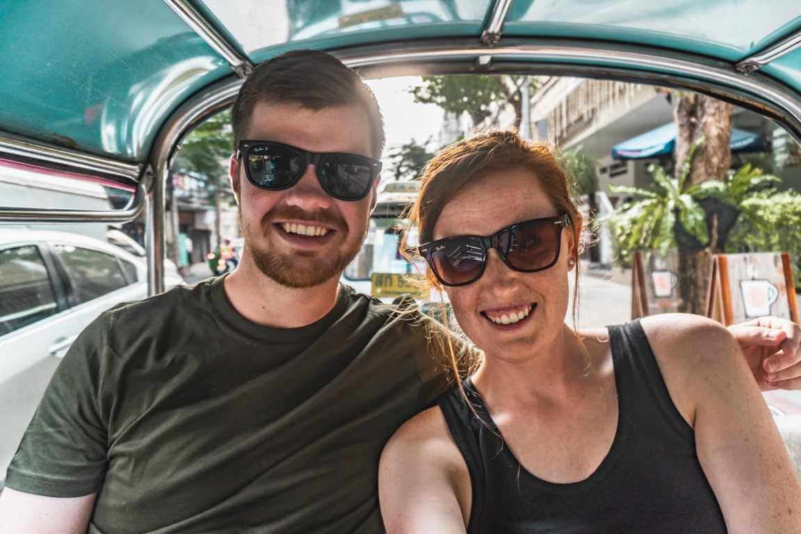 Two foreign teachers from South Africa living and working in Malaysia taking a selfie in the back of an open air taxi