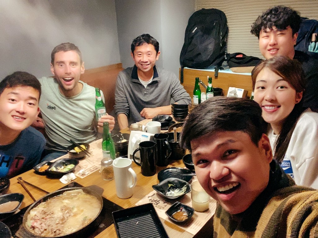 A group of students studying Chinese in Taiwan all eating and drinking together on a night after class