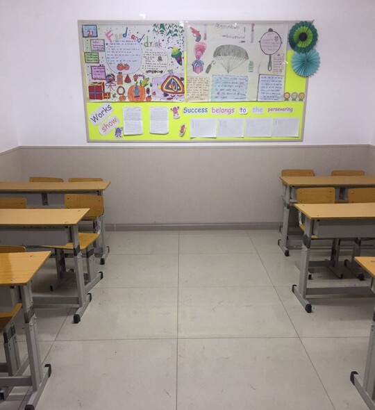 A look inside an English classroom in China with desks and student art on the wall