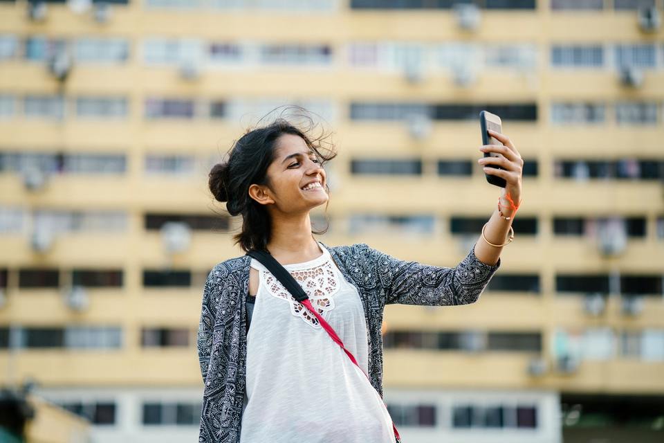 A solo female traveler having fun and taking a selfie abroad