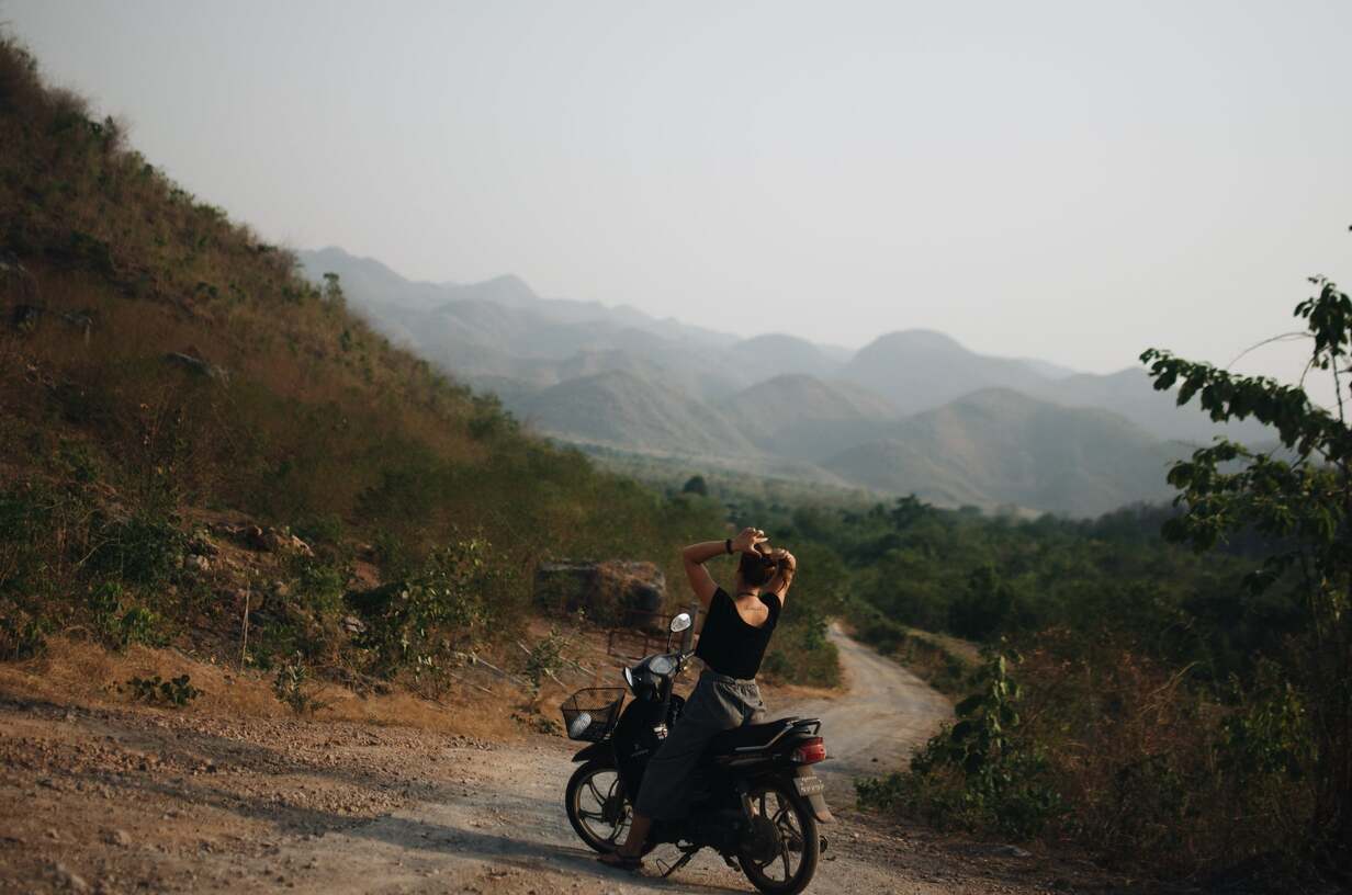 Foreigner in Myanmar riding a motorbike in the countryside