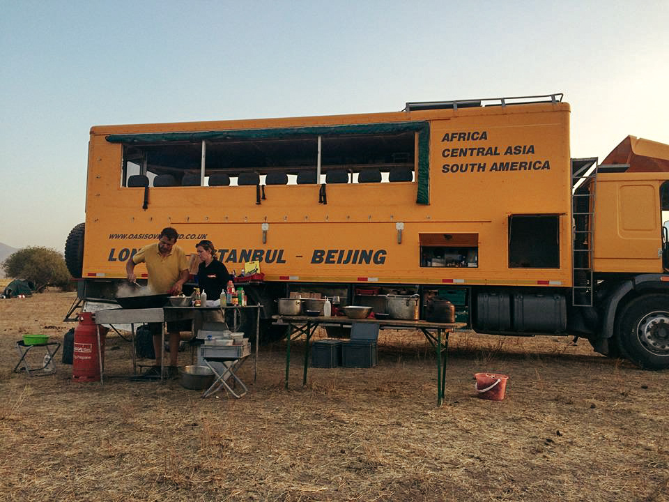 Yellow overland tour bus making dinner in Kazakhstan with Oasis Overland