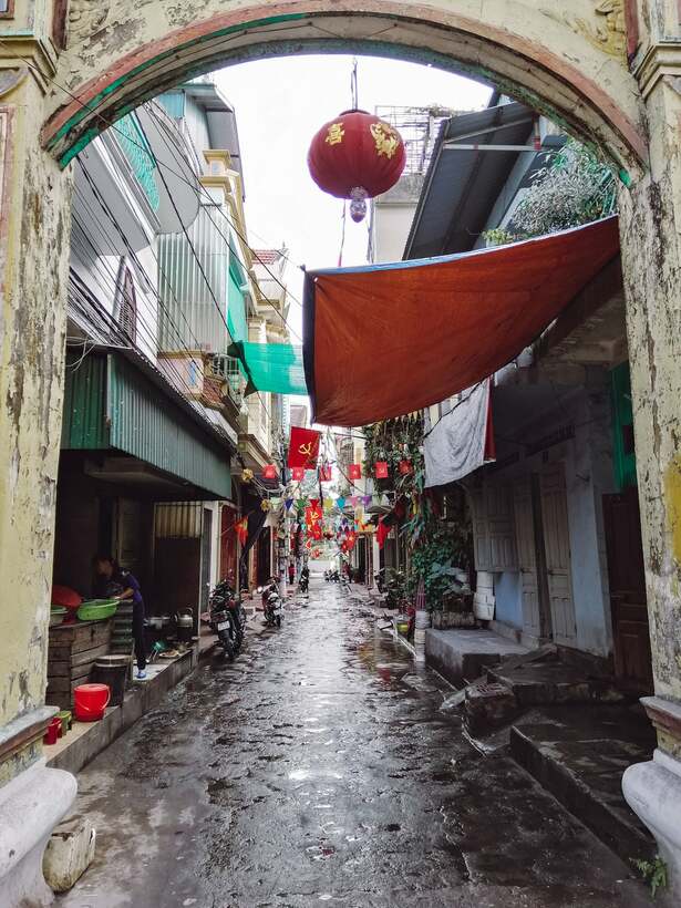 Small town alley in Vietnam with lanterns and Vietnamese flags