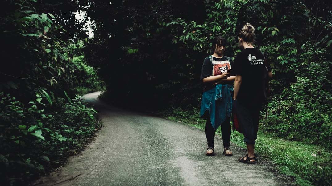 New women walking down a path in the jungle of Malaysia