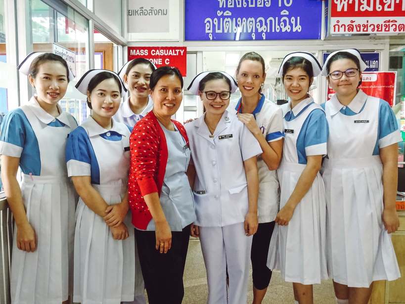 An international travel nurse with her co-workers in Thailand