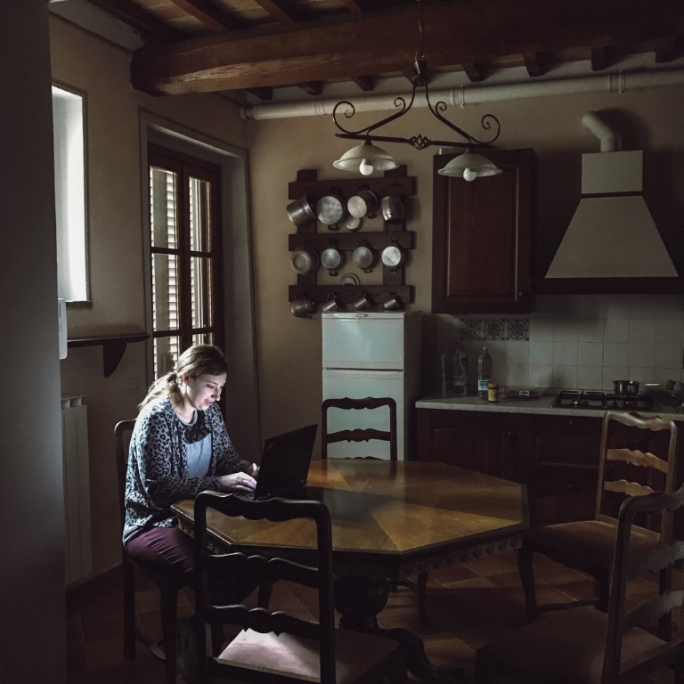 American expat working from home in her kitchen in Florence, Italy