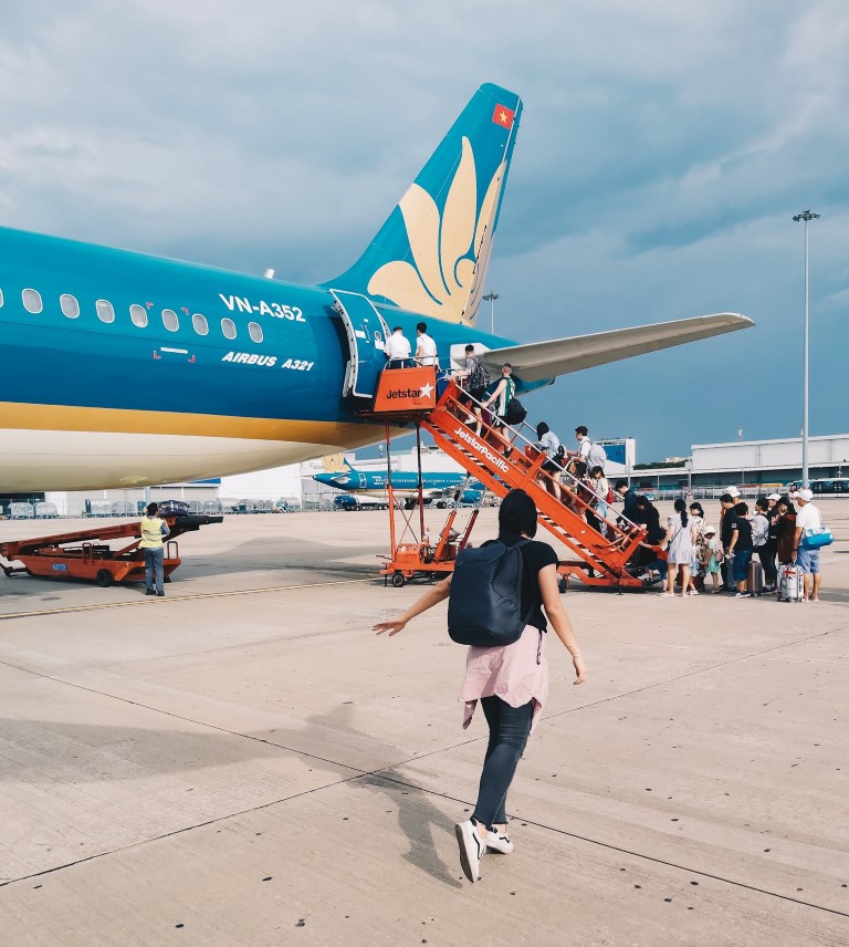 a women walking to a Vietnam Airlines flight in Ho Chi Minh, City