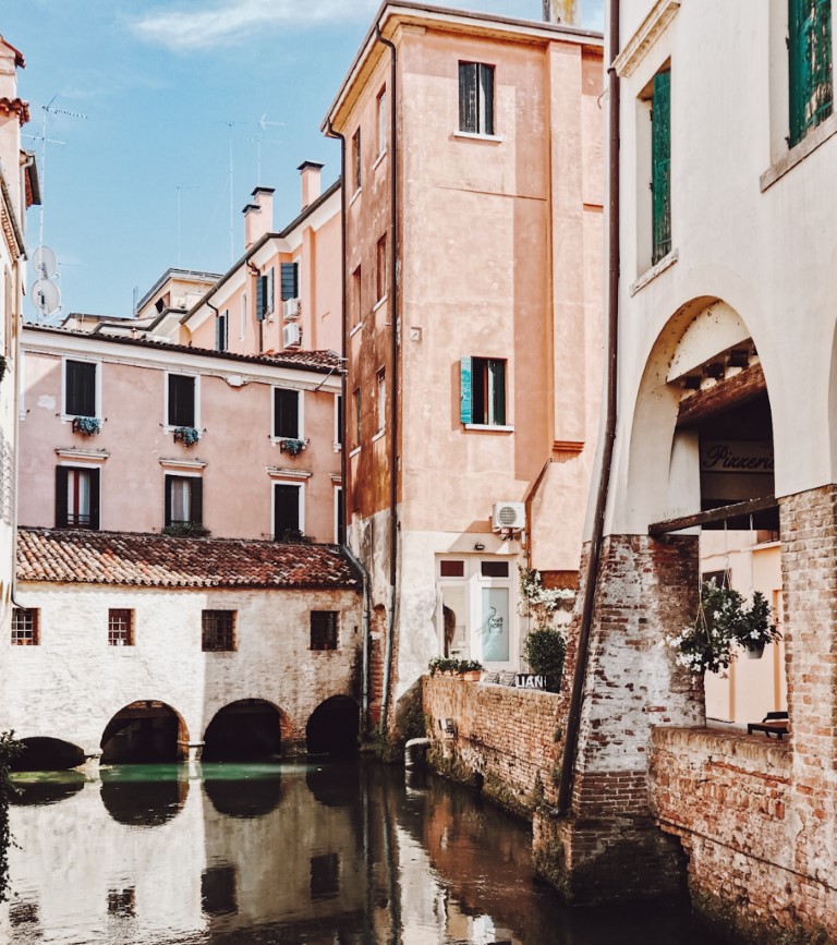 Beautiful corner in Treviso, Northern Italy with pastel colored houses and canals running underneath
