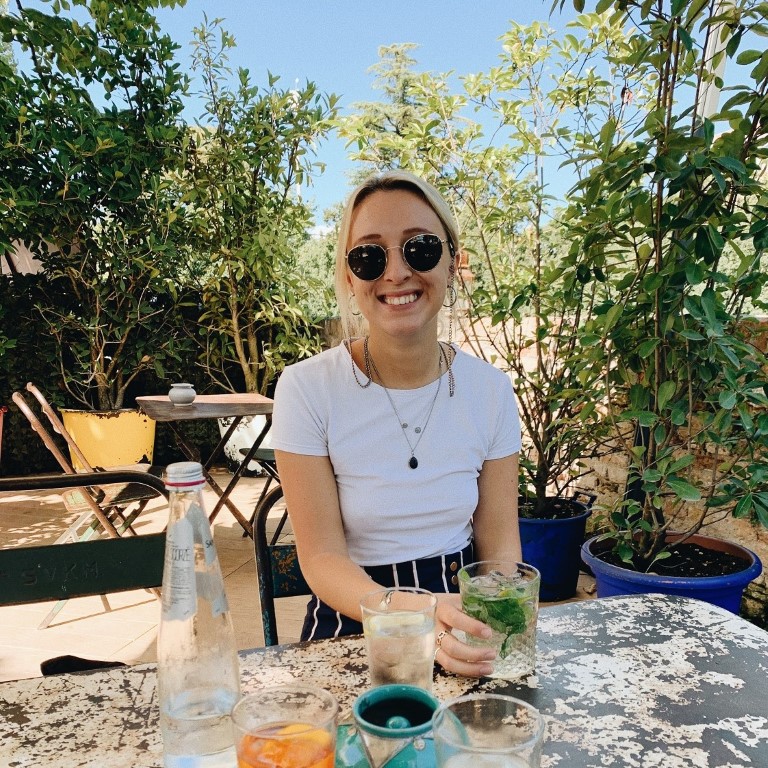 British expat living abroad in northern Italy sitting at an outdoor cafe