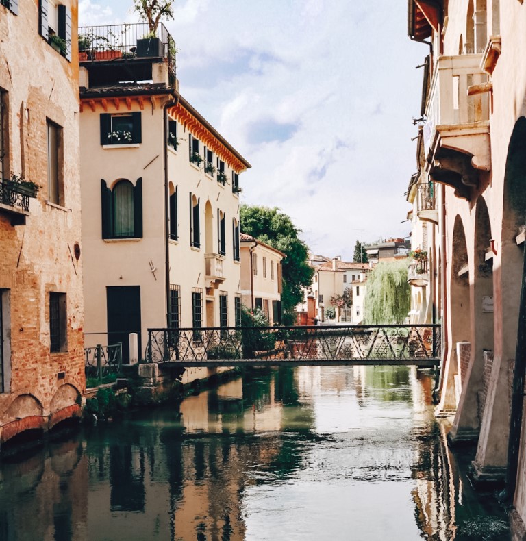 The canal streets in Treviso Italy with beautiful houses and patios on either side