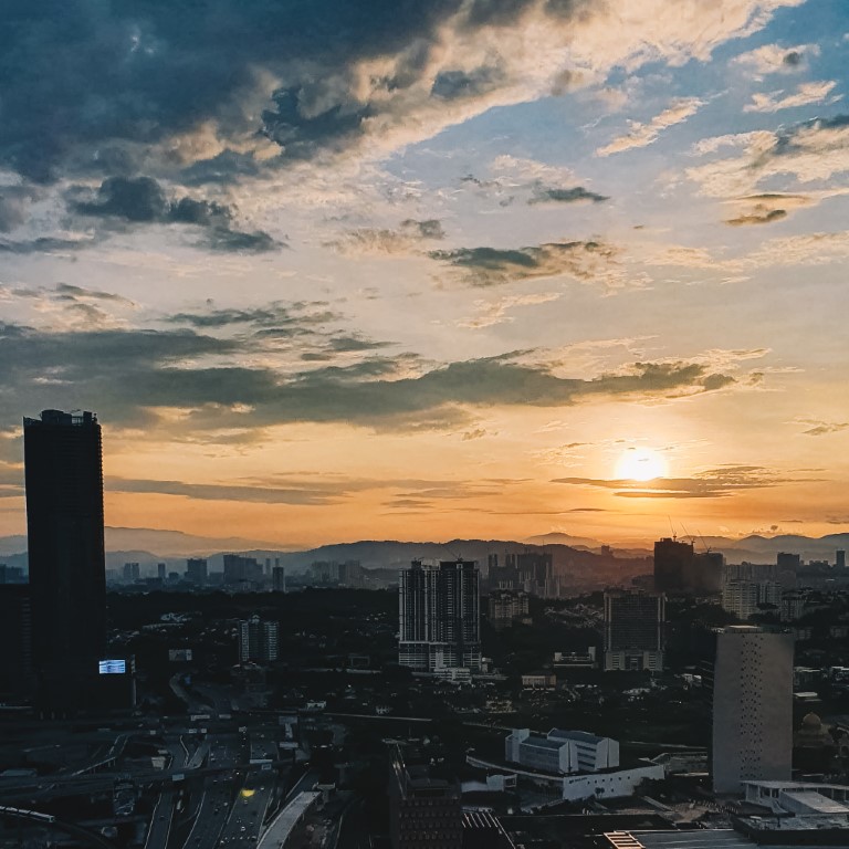 a beautiful sunrise over the city of Kuala Lumpur on a clear morning