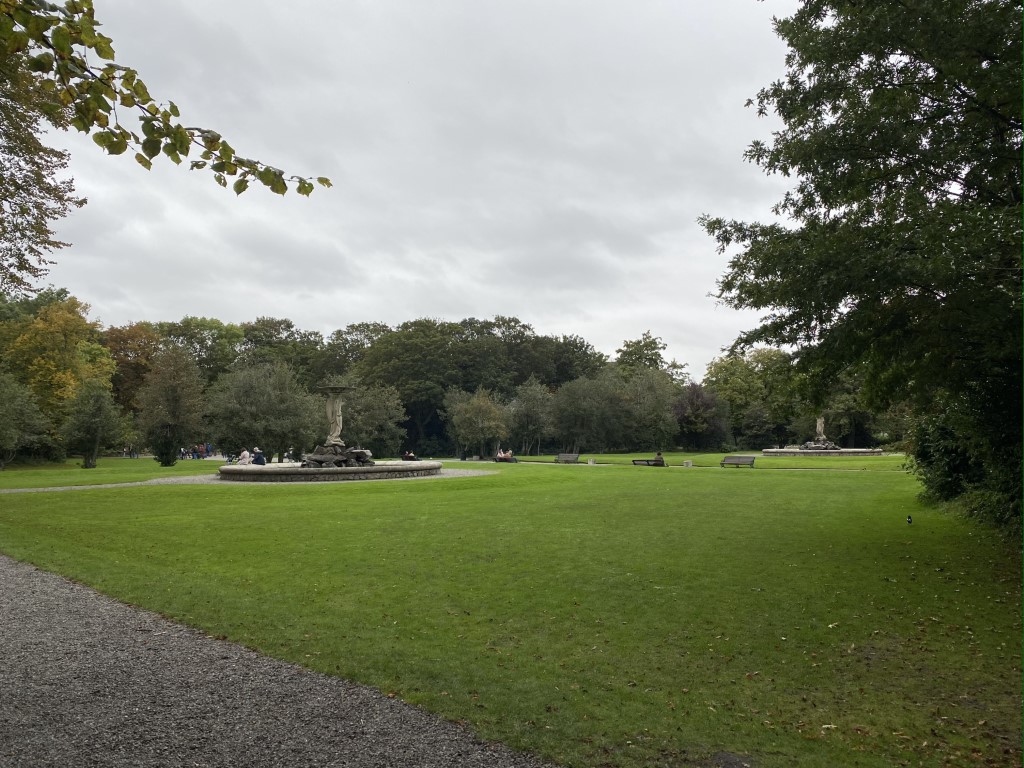 green grass, fountains, and benches in a quiet park in dublin
