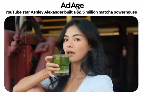 YouTube star Ashley Alexander holding a glass of green matcha drink.