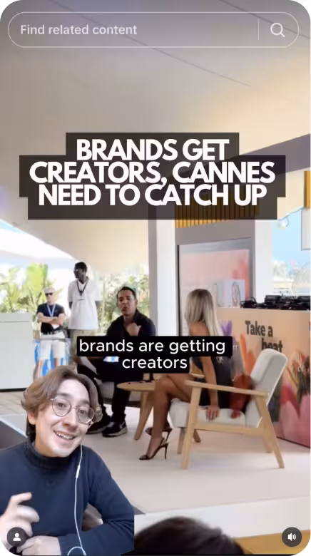 Indoor scene with people sitting and conversing under text reading 'BRANDS GET CREATORS, CANNES NEED TO CATCH UP' and a search bar above.