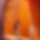 Blurred close-up of an orange and brown object or background with indistinct details.