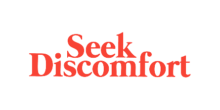Text reading 'Seek Discomfort' in red serif font on black background.