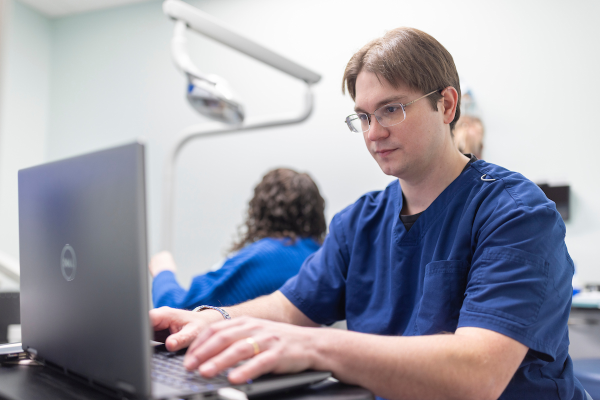 Dentist smiling in examination room 