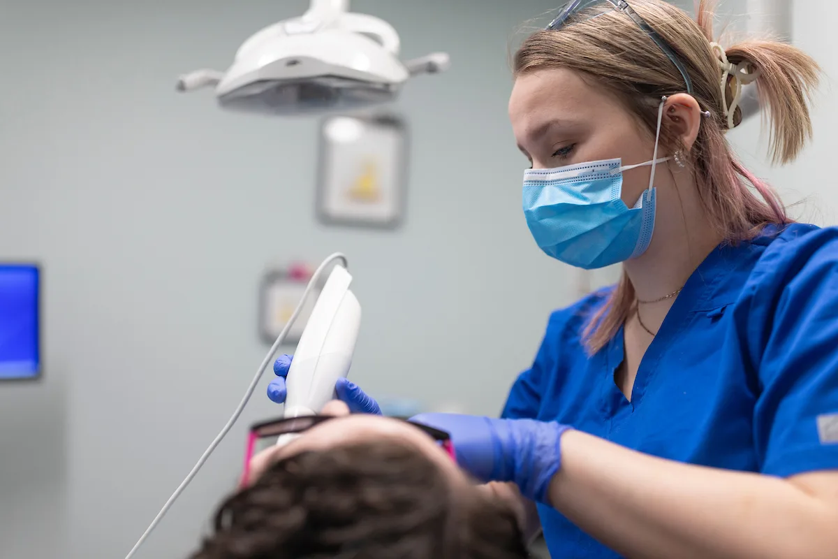 man holding his knocked out tooth