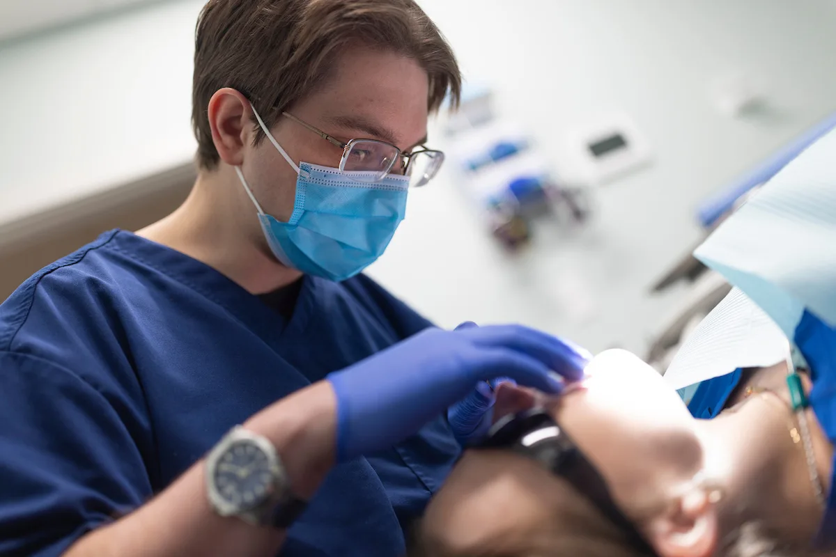 dentist showing little boy how to brush his teeth!