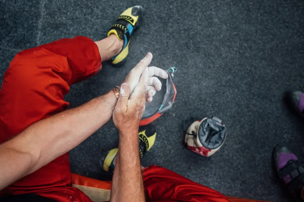 Chalking the Hands Before a Climb