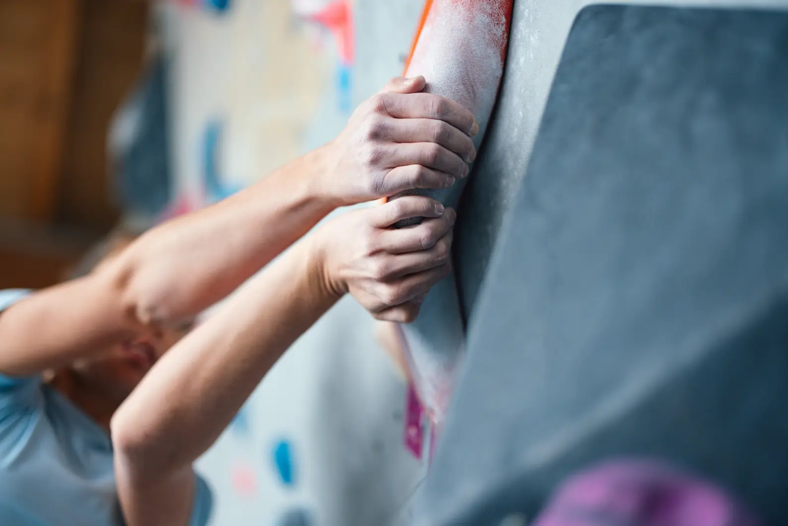 Close-Up of Climbers Hands on an Indoor Climbing Wall