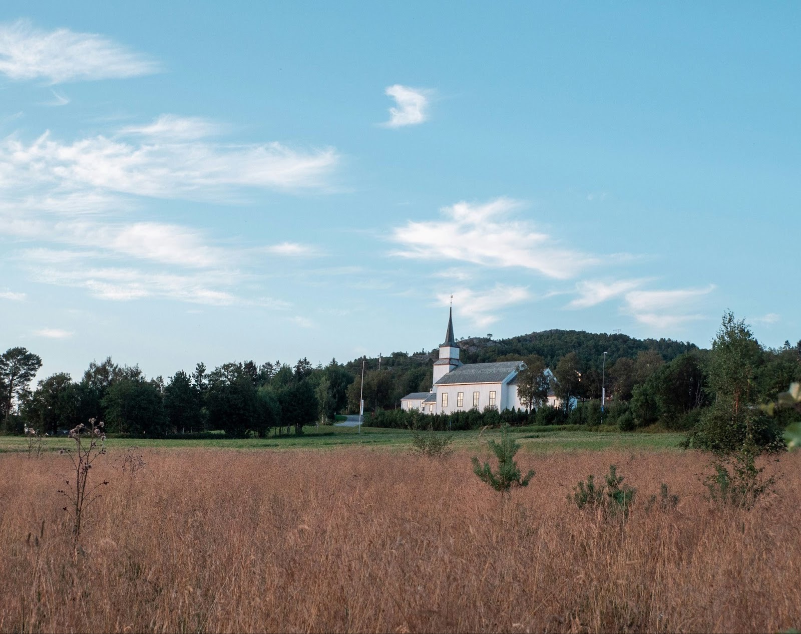 A white church in a field.