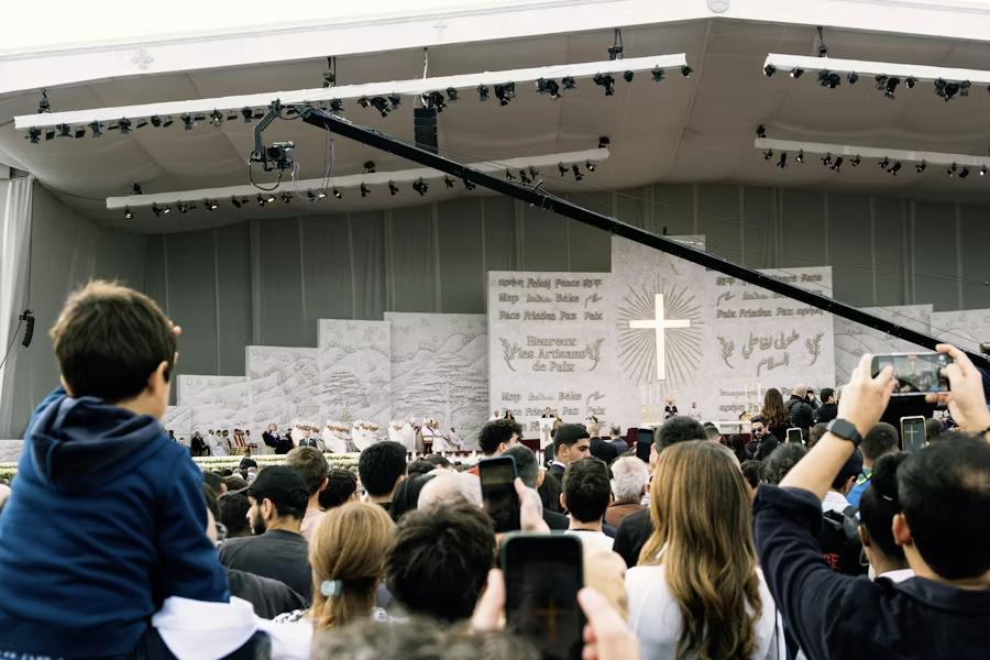 A large religious gathering with a crowd of worshippers.