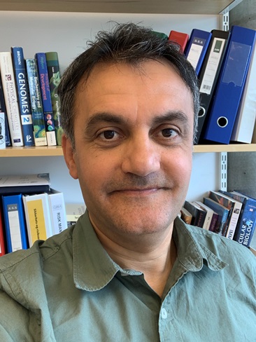 A middle-aged man with dark hair and dark eyes