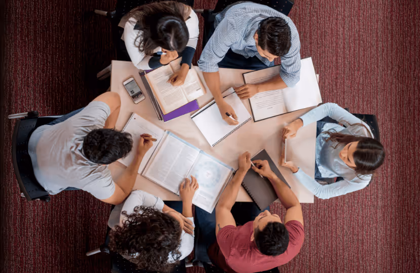 Image of students gathered around a desk