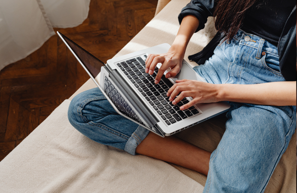 Image of student writing on a laptop