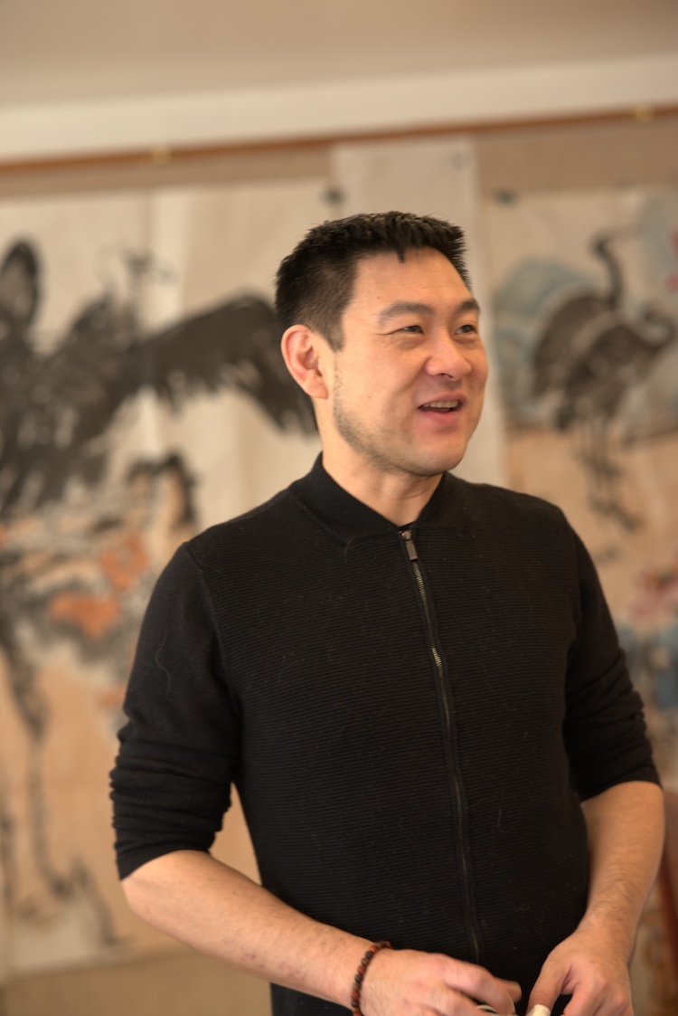 Xiao Yu Wang smiling in the clinic's painting room