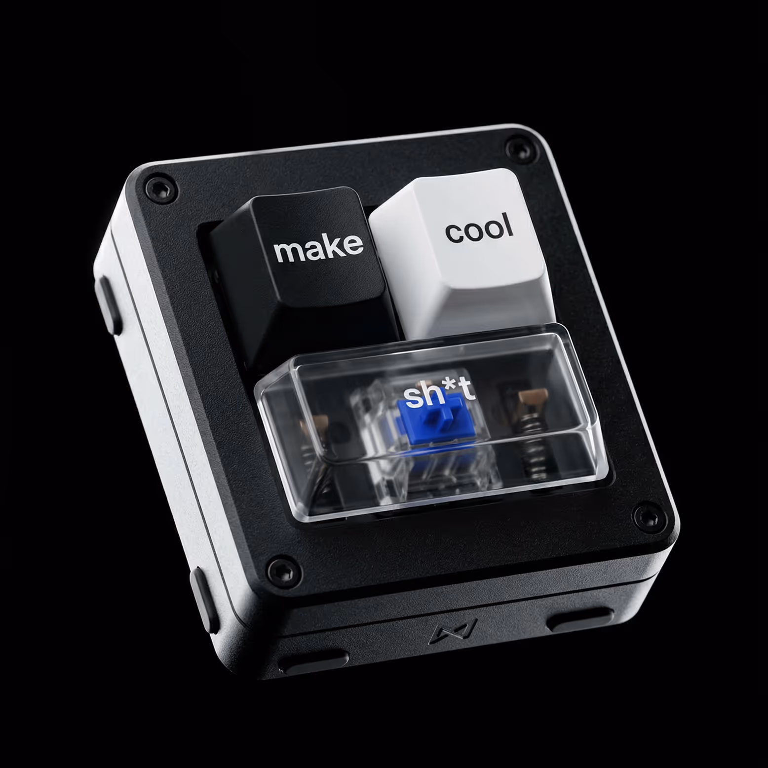 Small mechanical keyboard with three keycaps labeled 'make', 'cool', and 'sh*t' under a clear cover.