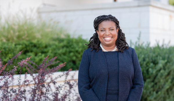 LaTida Smith stands and smiles outside The Winston-Salem Foundation office.
