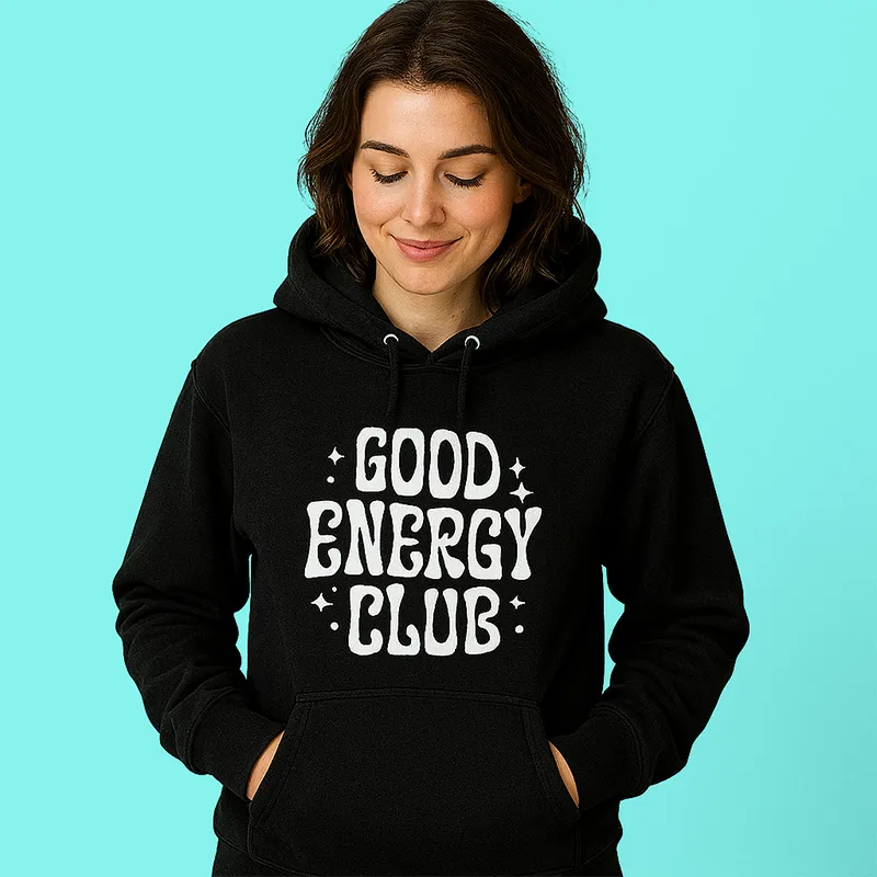 A woman wearing a black hoodie that says good energy club.