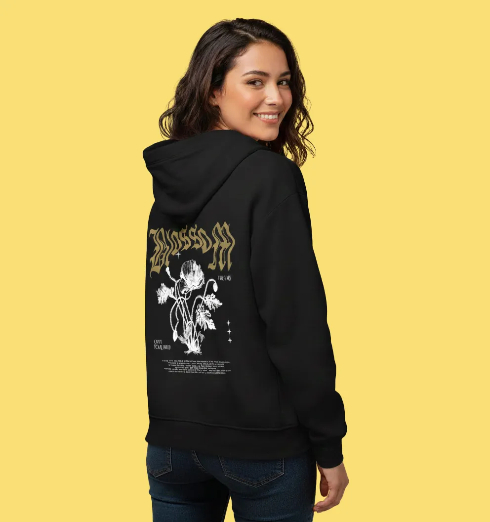 A woman wearing a black hoodie with a graphic on it.