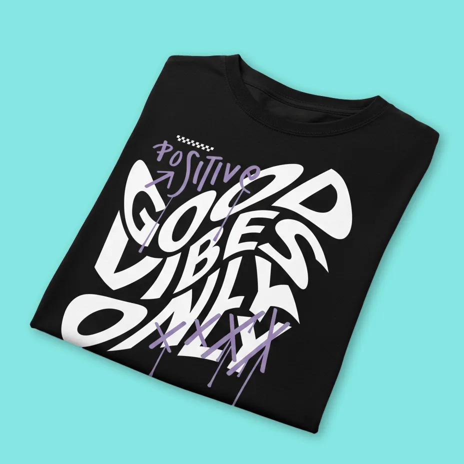 A black t - shirt with graffiti writing on it.