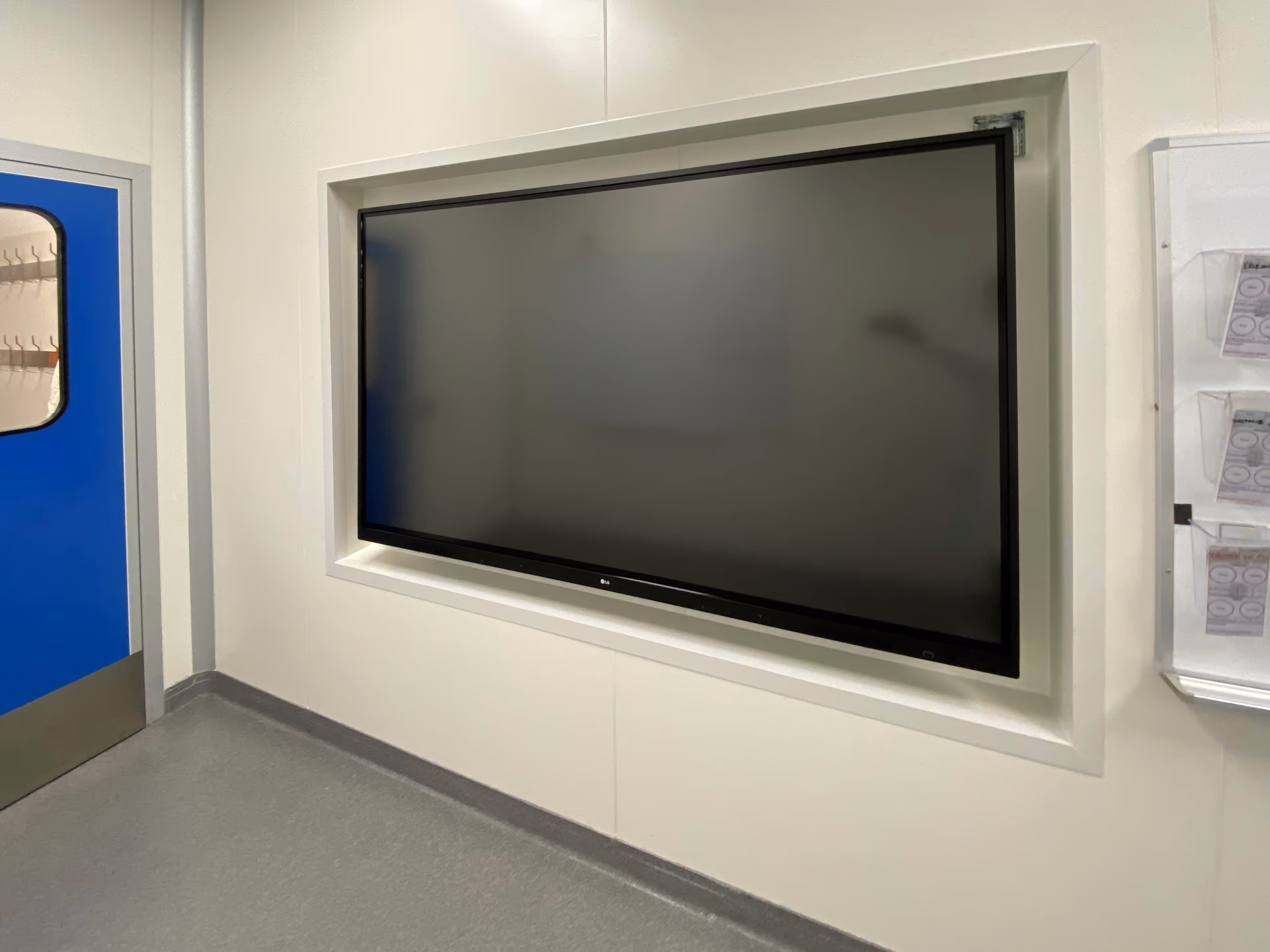 An example of cleanroom accessories integration: a monitor mounted in a cleanroom wall