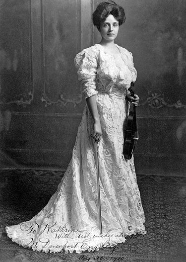 A woman in a long, white Victorian dress.