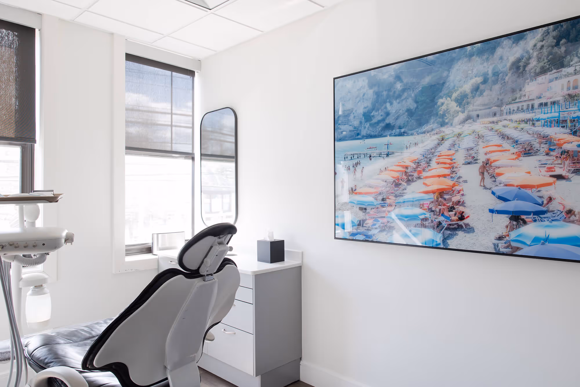 A chair in a room with a painting on the wall.