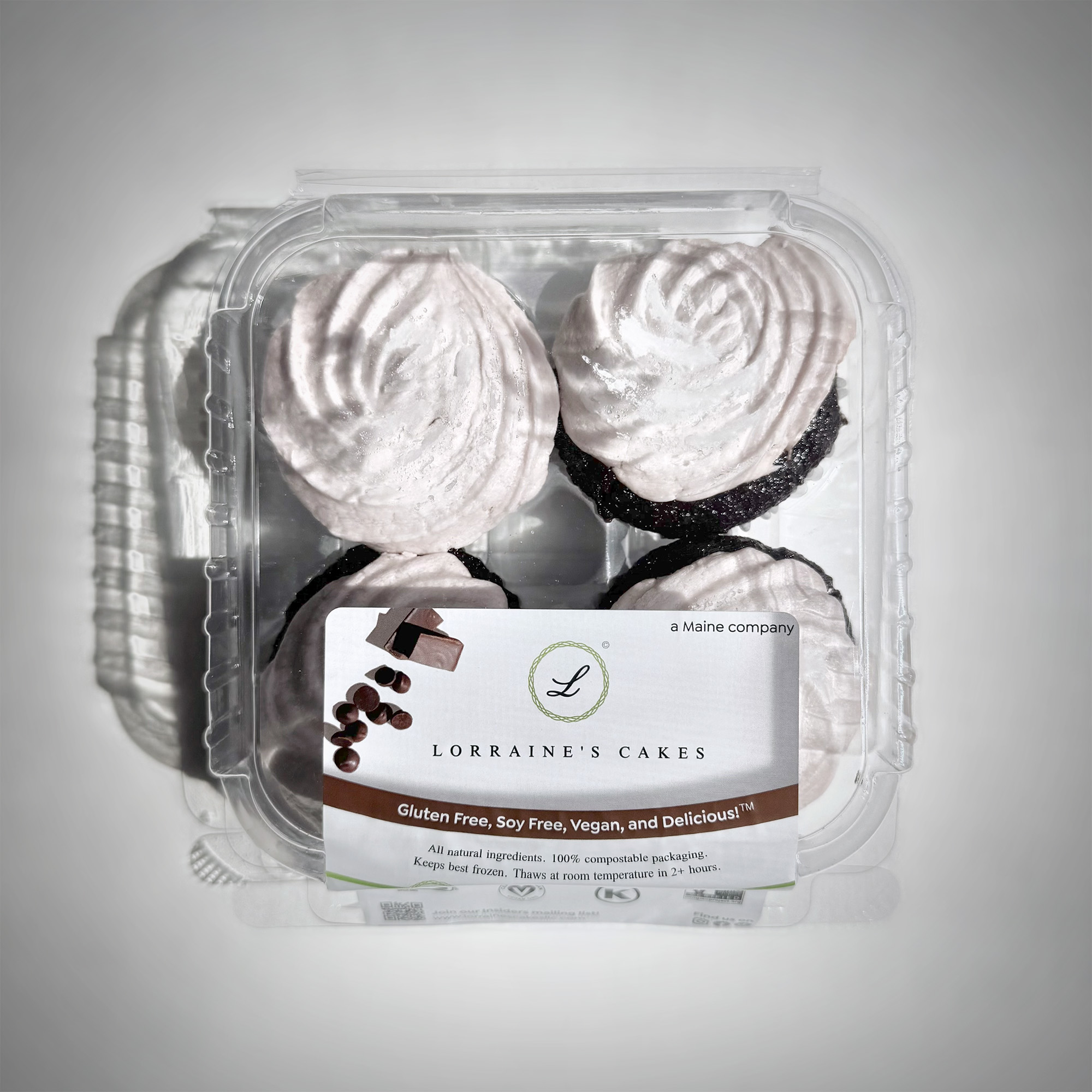 A top-down view of a set of four Lorraine's Cakes chocolate cupcakes in their package: a compostable plastic label printed with branded graphics adhered to a clear, compostable plastic container.
