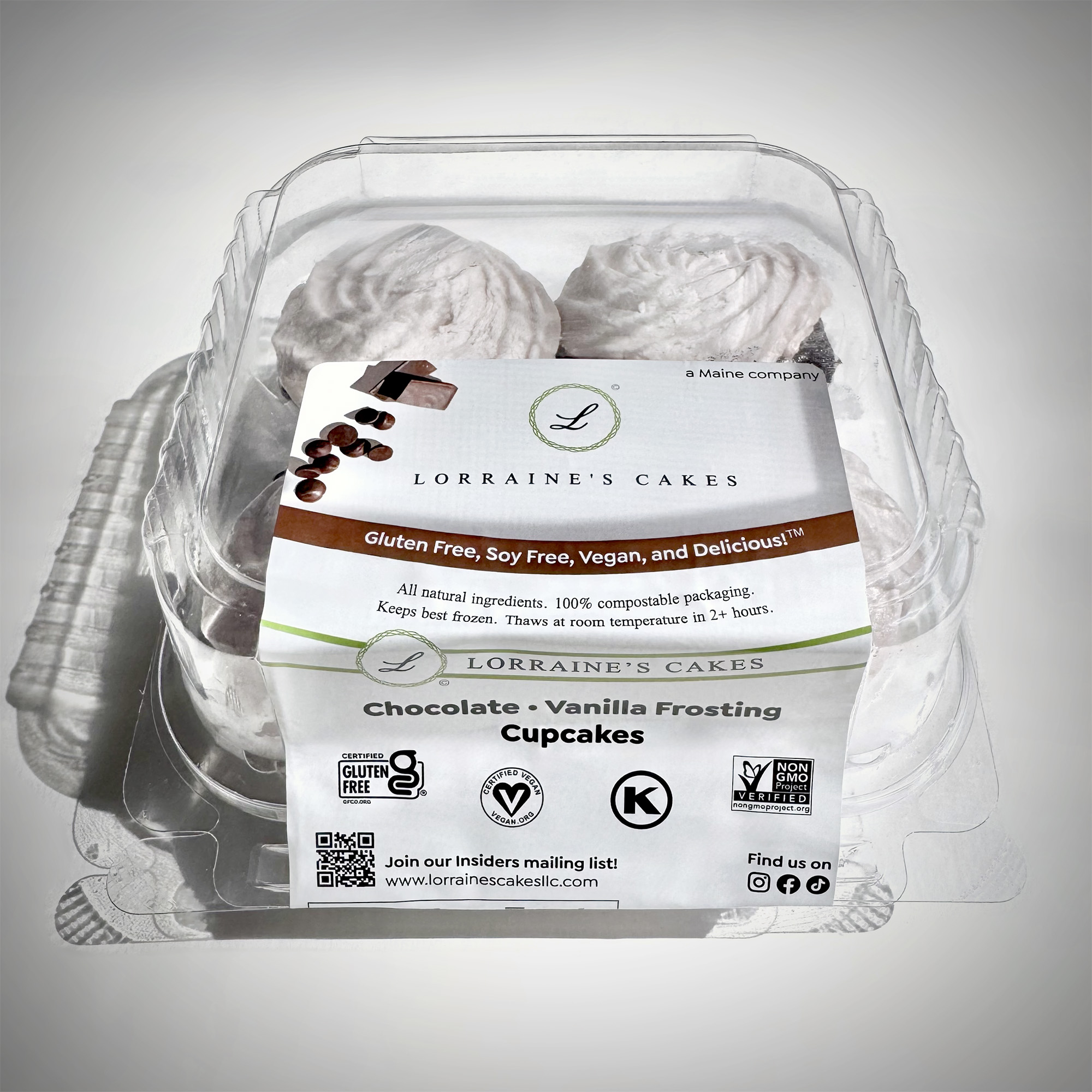 A three-quarter–angle view of a 4-pack of Lorraine's Cakes chocolate cupcakes in their package: a compostable plastic label printed with branded graphics adhered to a clear, compostable plastic container.