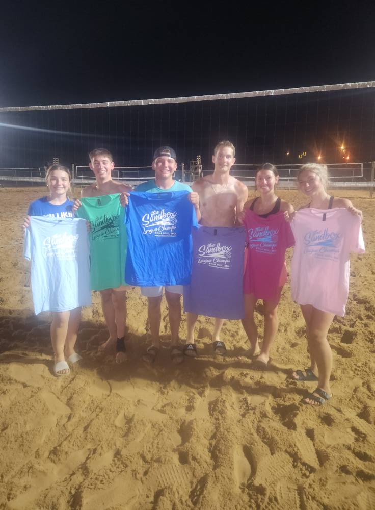 picture of a group of volleyball players wearing the sandbox volleyball logo t-shirts