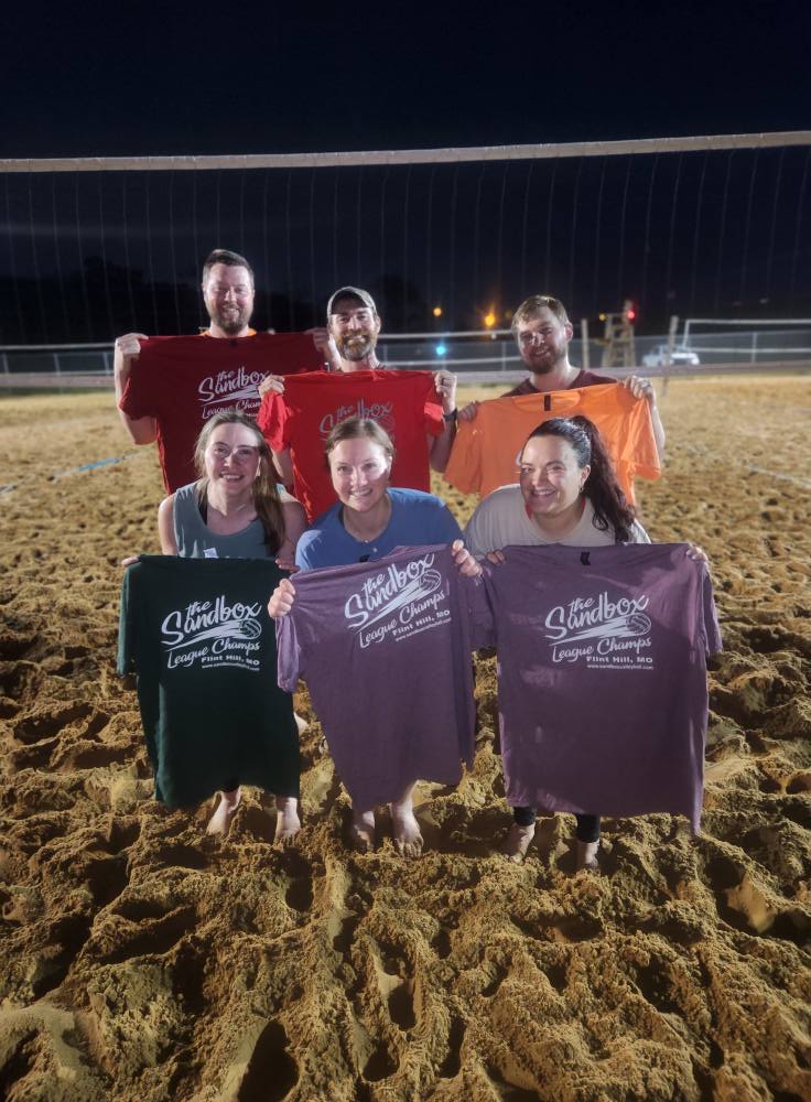 picture of a group of volleyball players wearing the sandbox volleyball logo t-shirts